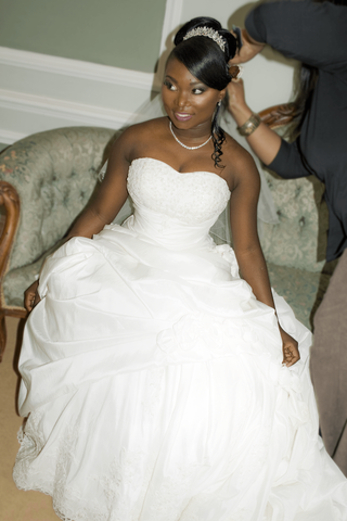 Bridal updo with a high bun and sweep. loose tendrils.