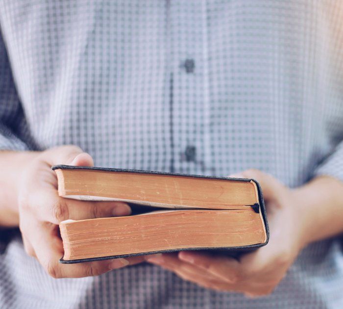 Man Holding Bible — Knoville, TN — Greater First Fellowship Church Of God In Christ