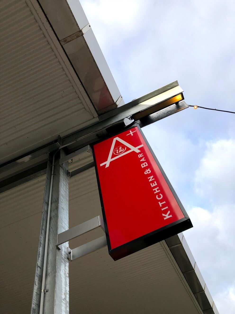 Red Signage Under The Roof — Signage In Acacia Ridge, QLD Red Signage Under The Roof — Signage In Acacia Ridge, QLD