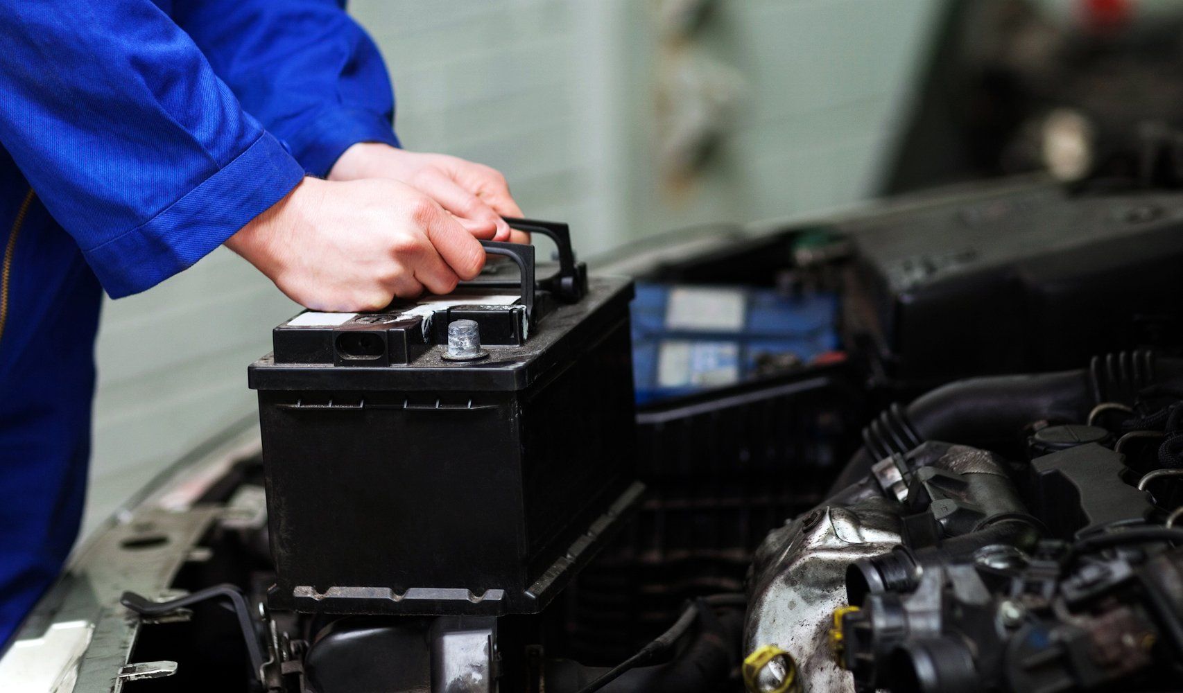 mechanic with car battery