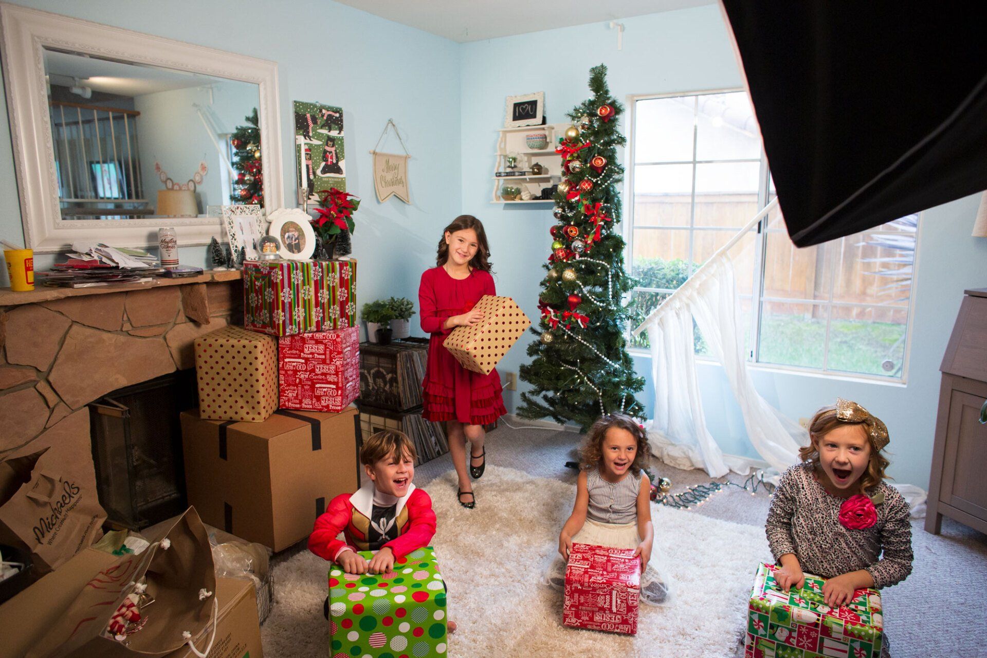 A family is posing for a picture in front of a christmas tree in a living room.