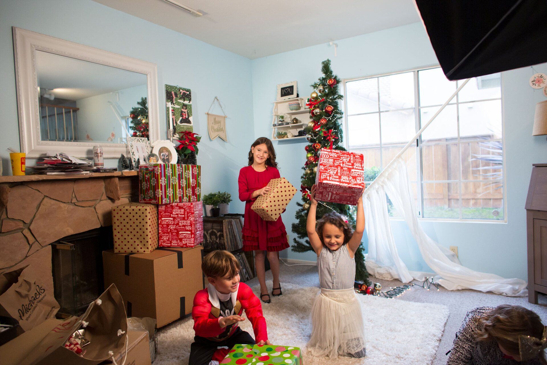 A group of children are playing in a living room decorated for christmas.
