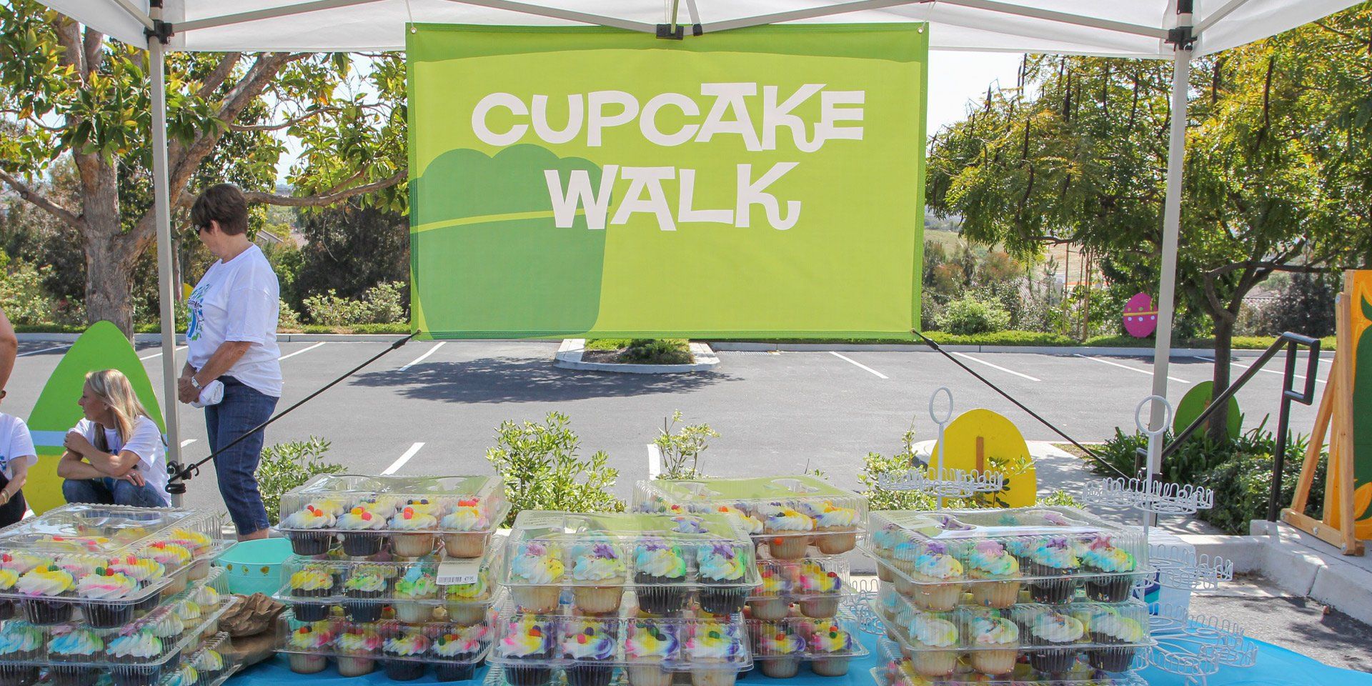 A cupcake walk is being held in a parking lot