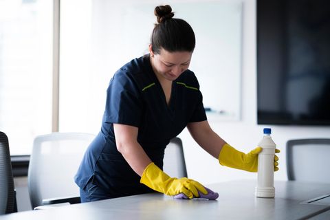 Home Cleaning — Woman Cleaning Office in Fort Wayne, IN