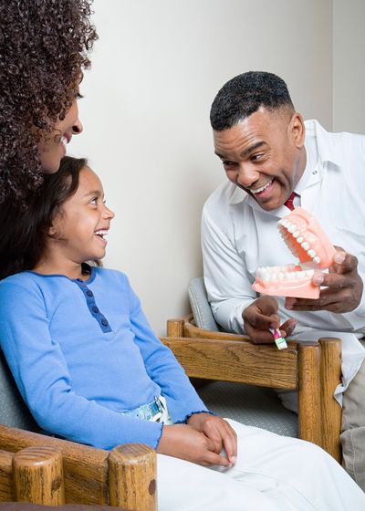 Dentist Showing Patient how To Clean Teeth — Atlanta, GA — Metro Dental