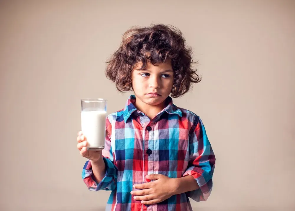 Kid Boy with Stomach Pain Holding a Glass of Milk — Hampstead, NC — Hampstead Medical Center PC Kid Boy with Stomach Pain Holding a Glass of Milk — Hampstead, NC — Hampstead Medical Center PC