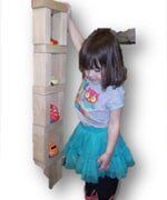 Little girl holding Shoe Rack — Child learning center in Loomis, CA Little girl holding Shoe Rack — Child learning center in Loomis, CA