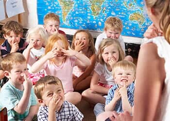 Montessori/Pre-School Class Listening to Teacher on Carpet — Child learning center in Loomis, CA Montessori/Pre-School Class Listening to Teacher on Carpet — Child learning center in Loomis, CA