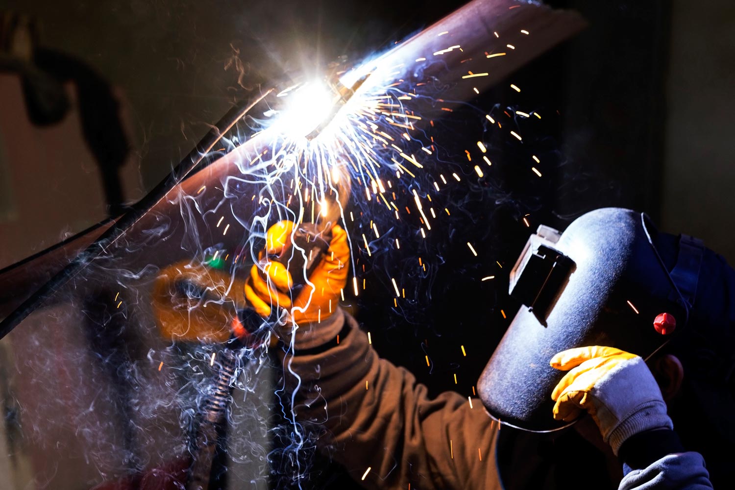 Welder Welding Steel Plates — Merrillville, IN — Northwest Indiana Fabrication LLC