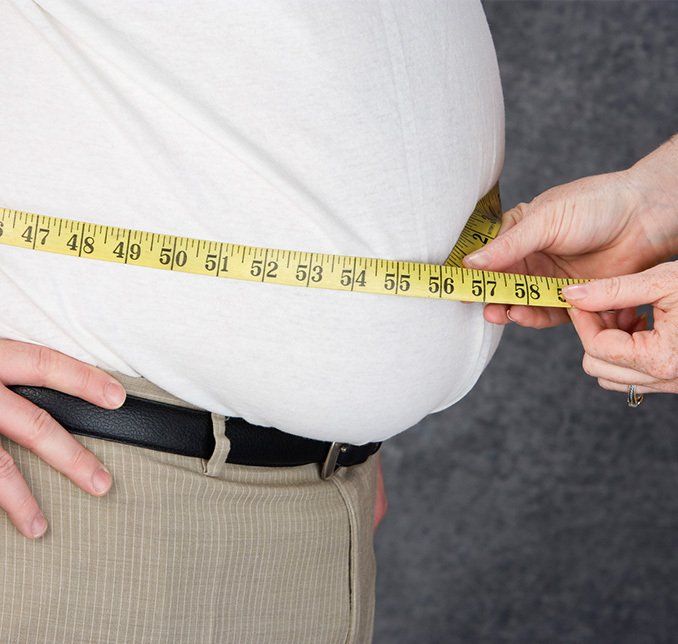 Overweight Man with Tape Measure — Park Ridge, IL — Athans and Associates