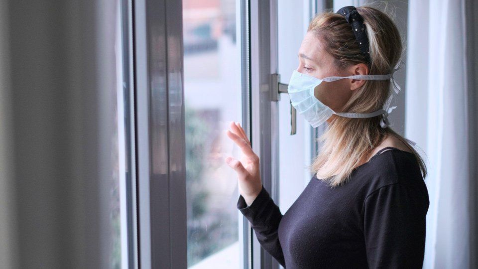 Woman Looking Out Of The Window — Park Ridge, IL — Athans and Associates Woman Looking Out Of The Window — Park Ridge, IL — Athans and Associates
