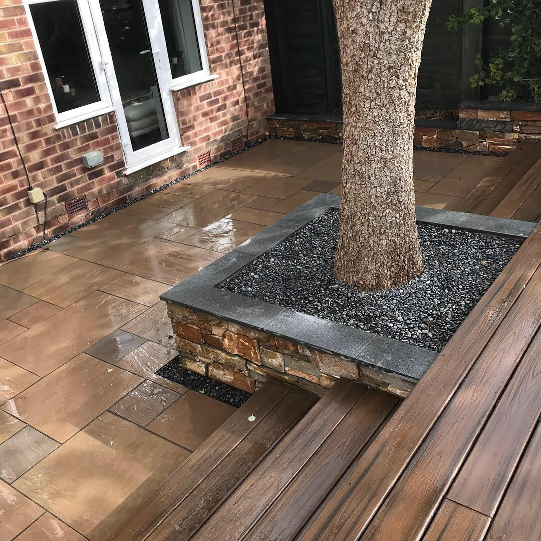 Patio surrounding a tree with wooden steps
