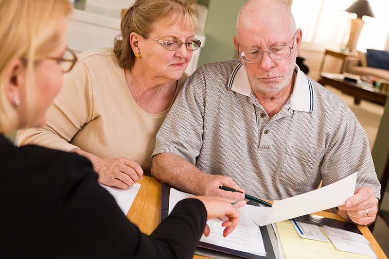  Old Couple Looking at a Document — Lumberton, NC — Realty One Group Heritage