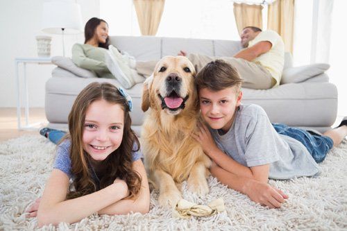 Happy Family With Their Dog — Lumberton, NC — Realty One Group Heritage