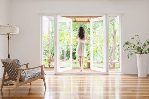 Woman Looking Out Window — Lumberton, NC — Realty One Group Heritage