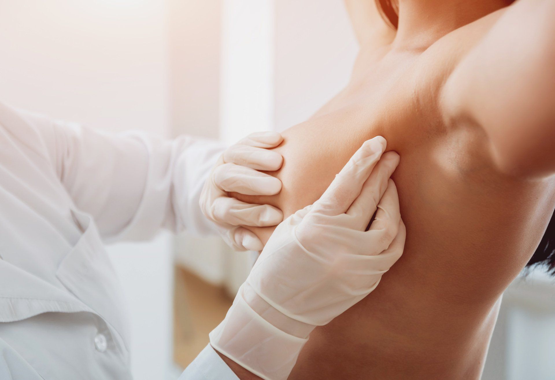 A doctor is examining a woman 's armpit.