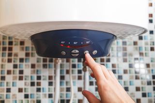 Hand Switching ON the Heater — Morris County, NJ — George’s Drains LLC Hand Switching ON the Heater — Morris County, NJ — George’s Drains LLC