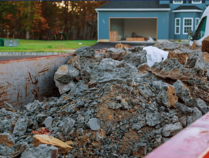 Roll off dumpster full of dirt and concrete