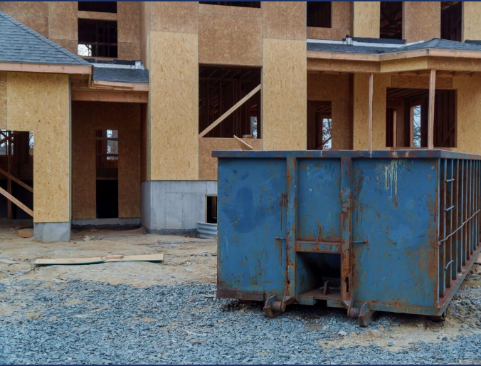 Roll off dumpster in front of new construction
