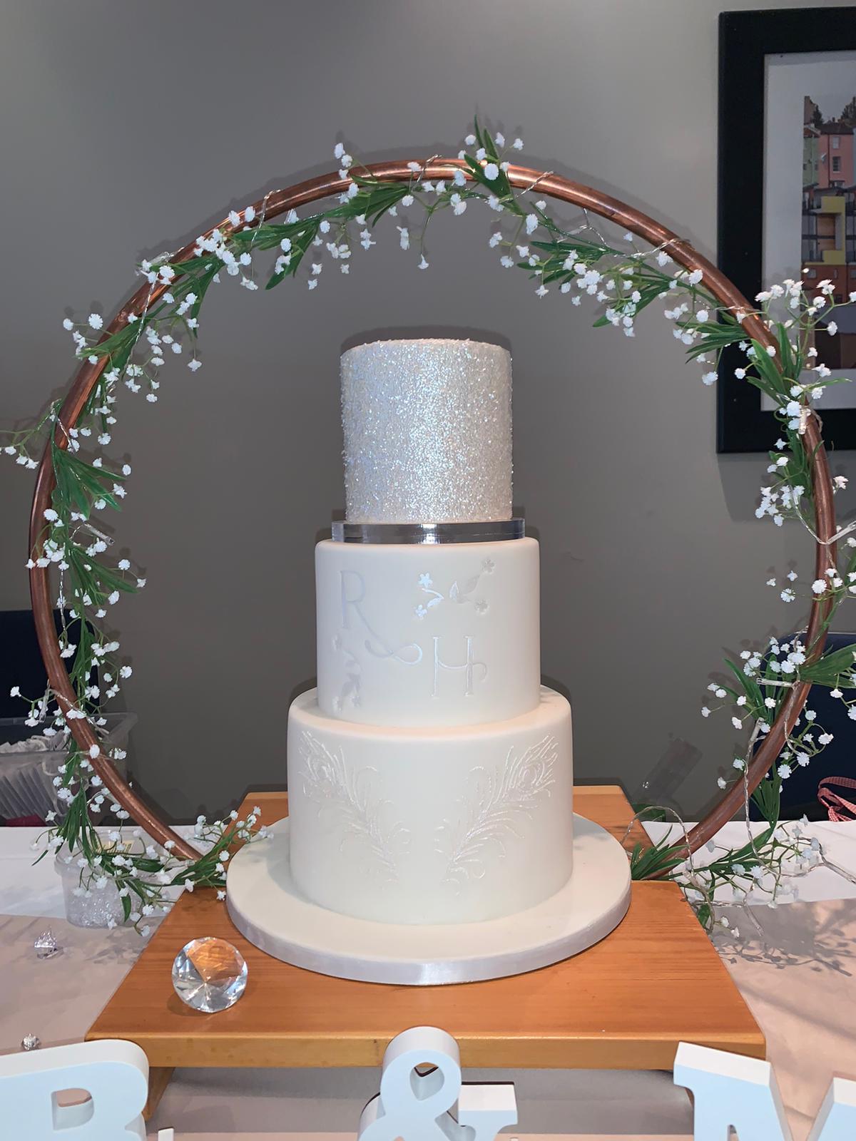 A white celebration cake with red detailing.
