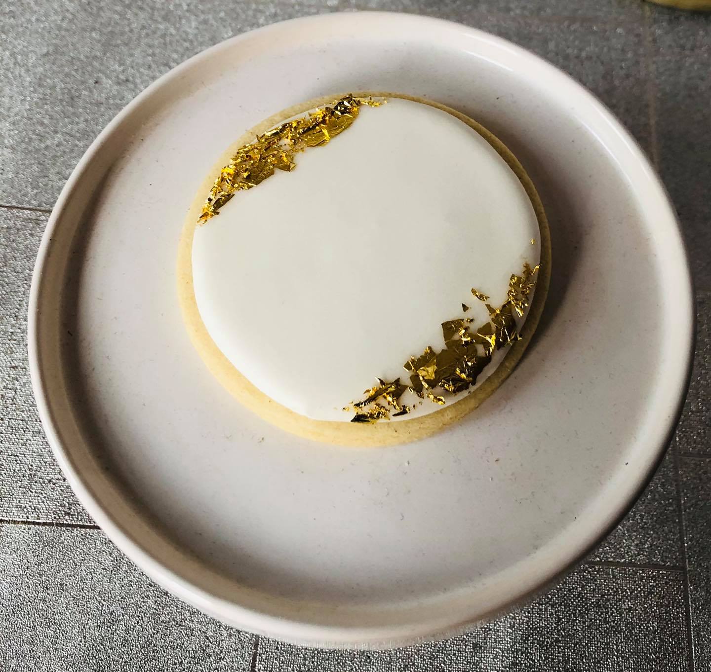 The top of a cake with decorative gold leaf.