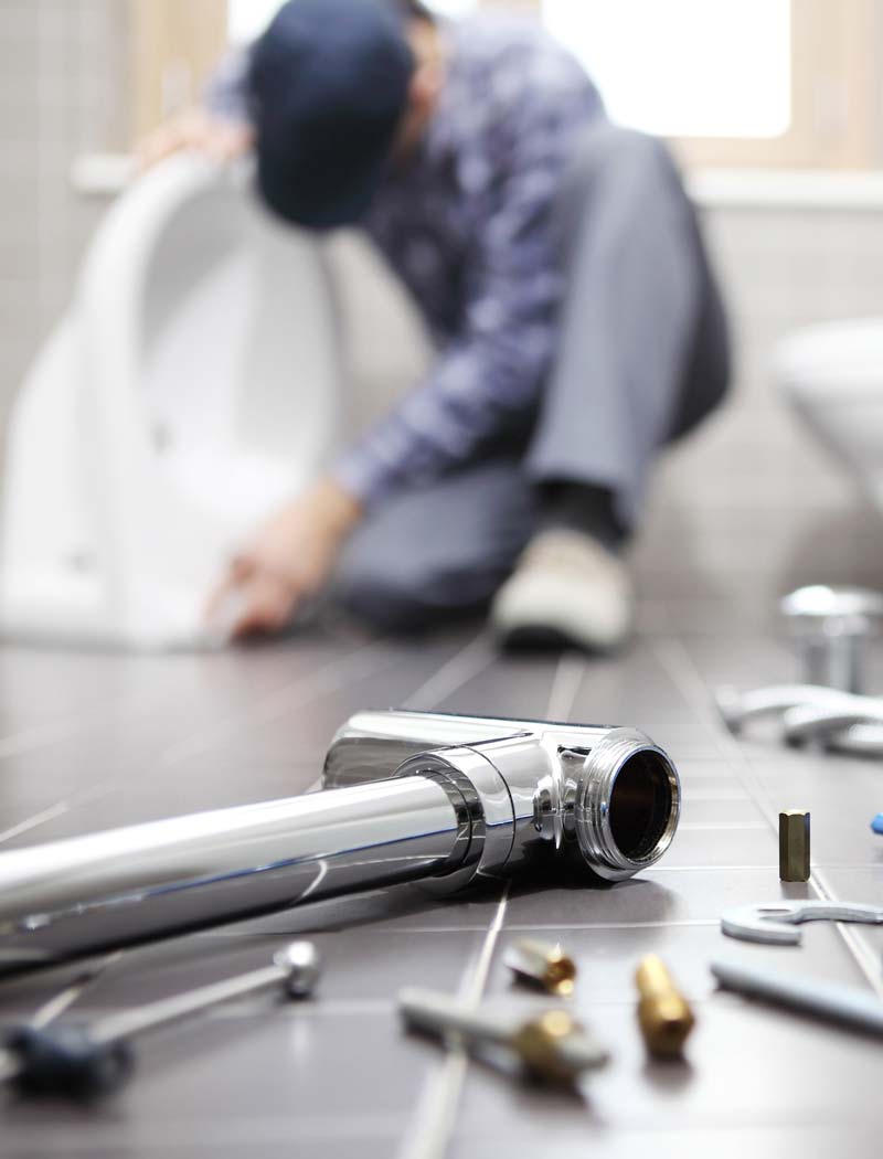 Man Fixing Plumbing System — Columbus, OH — Calhoun Plumbing A expert providing drain cleaning services in Columbus, OH