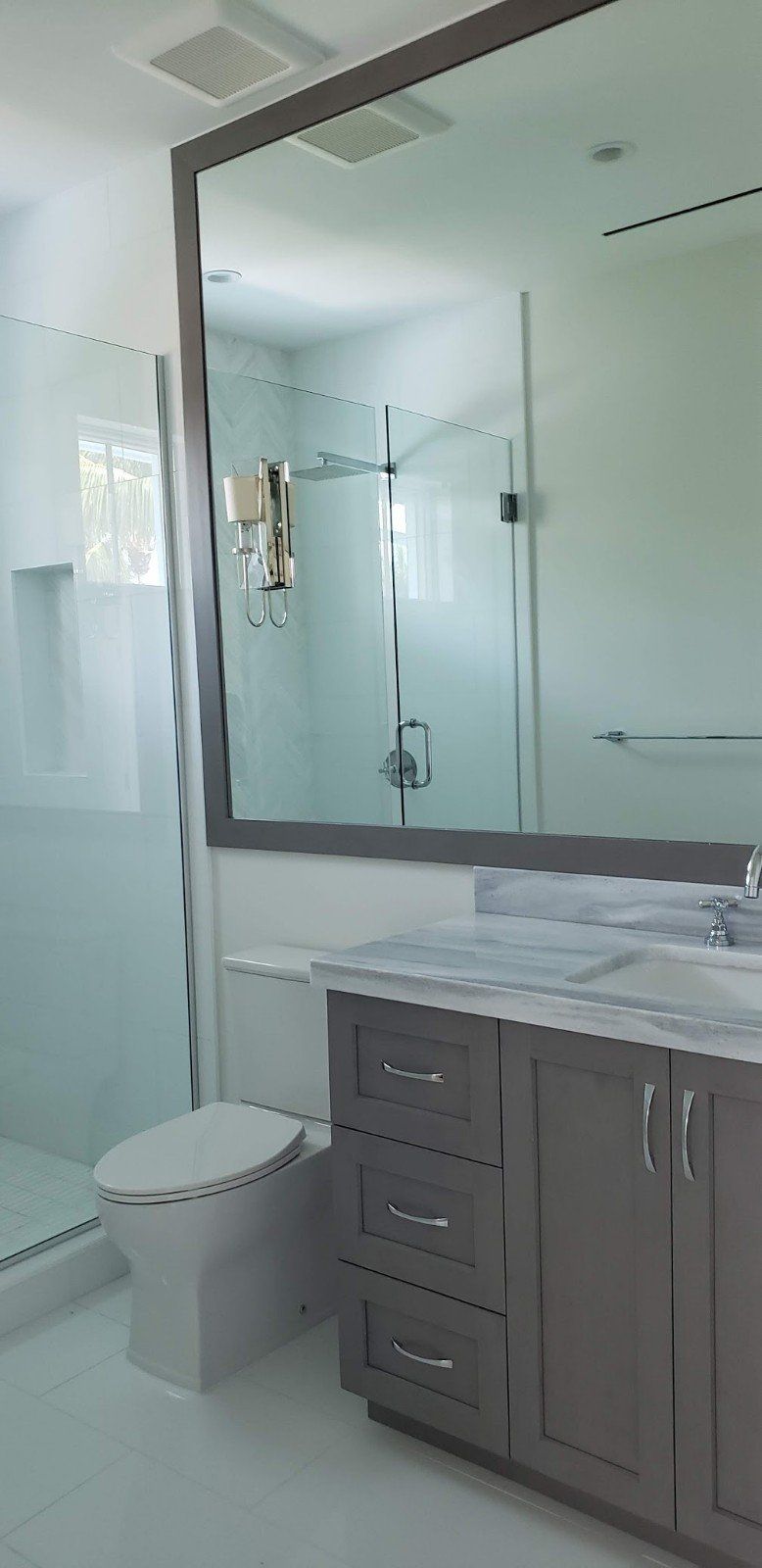 A Bathroom with Cabinet Beside the Toilet Bowl — Naples, FL — Rain Forest Marble Inc.
