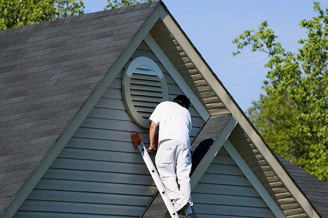 Painter Working at Roof — Okemos, MI — Tony Grant’s Painting Company
