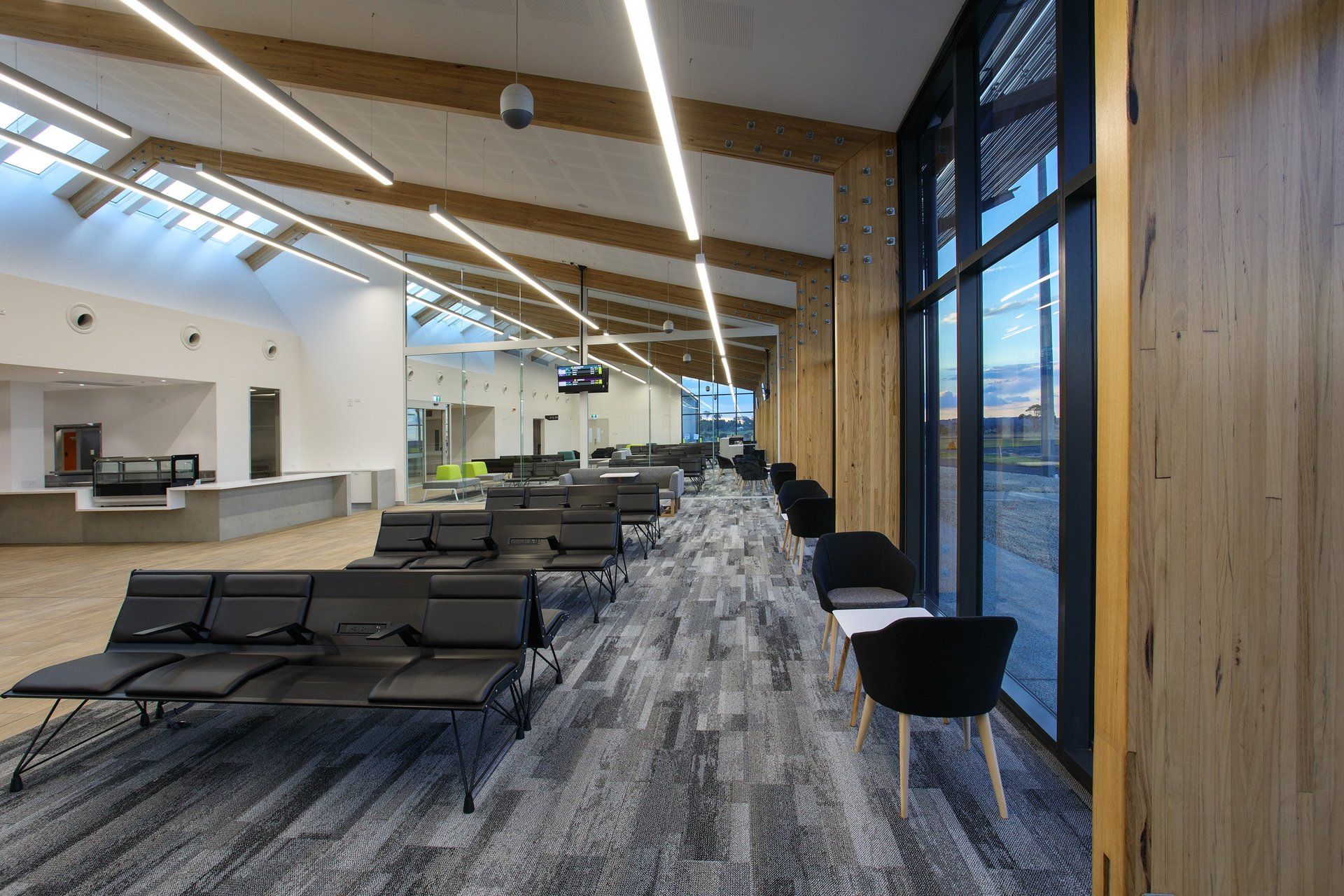 Long shot of chairs in the waiting area of armidale airport .