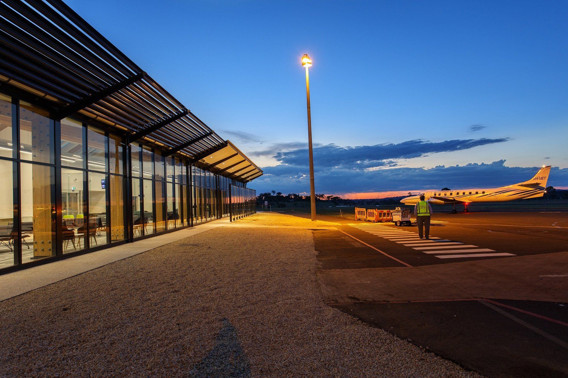 View of plane and exterior of armidale airport in the evening