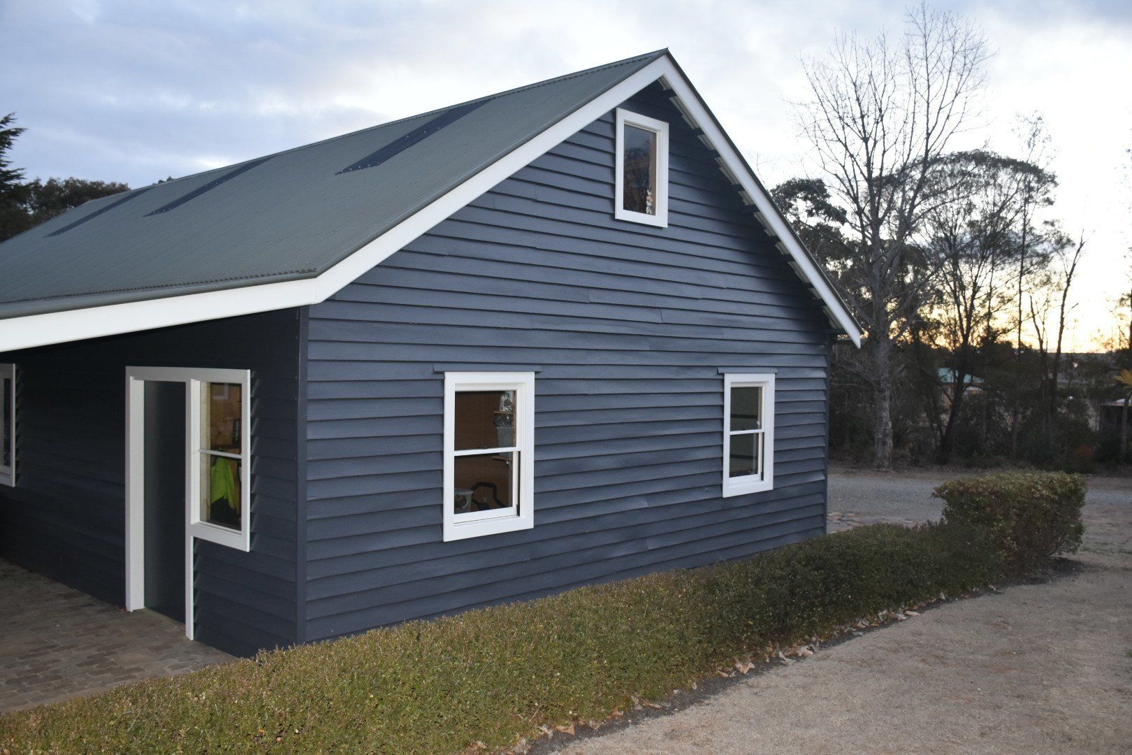 Garage with four windows and dark blue walls