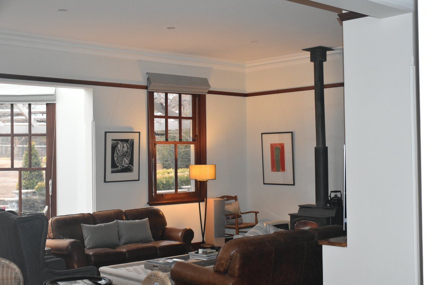 a living room filled with furniture and a fireplace with white walls 