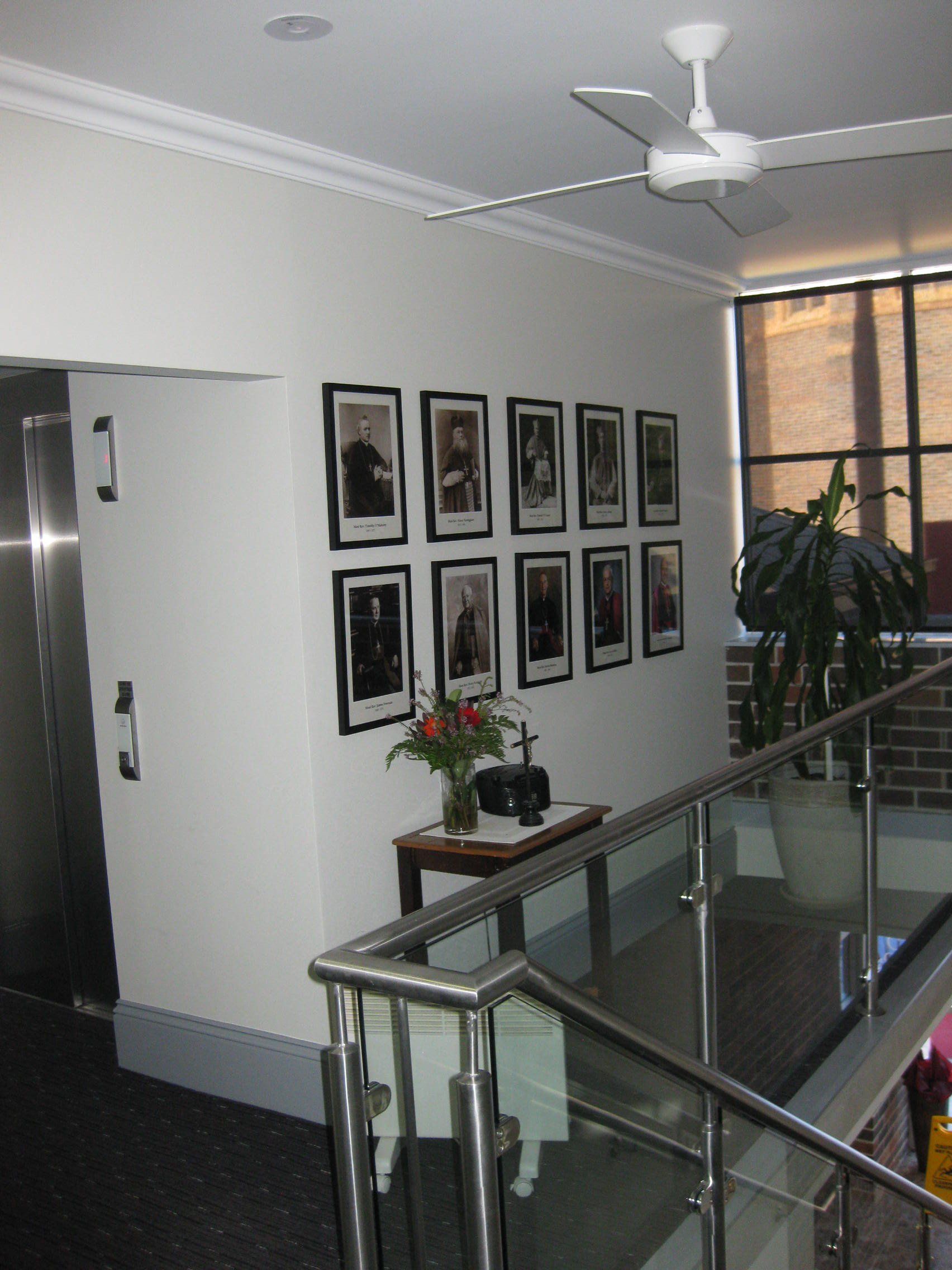 Crisp painted white walls with portraits on wall