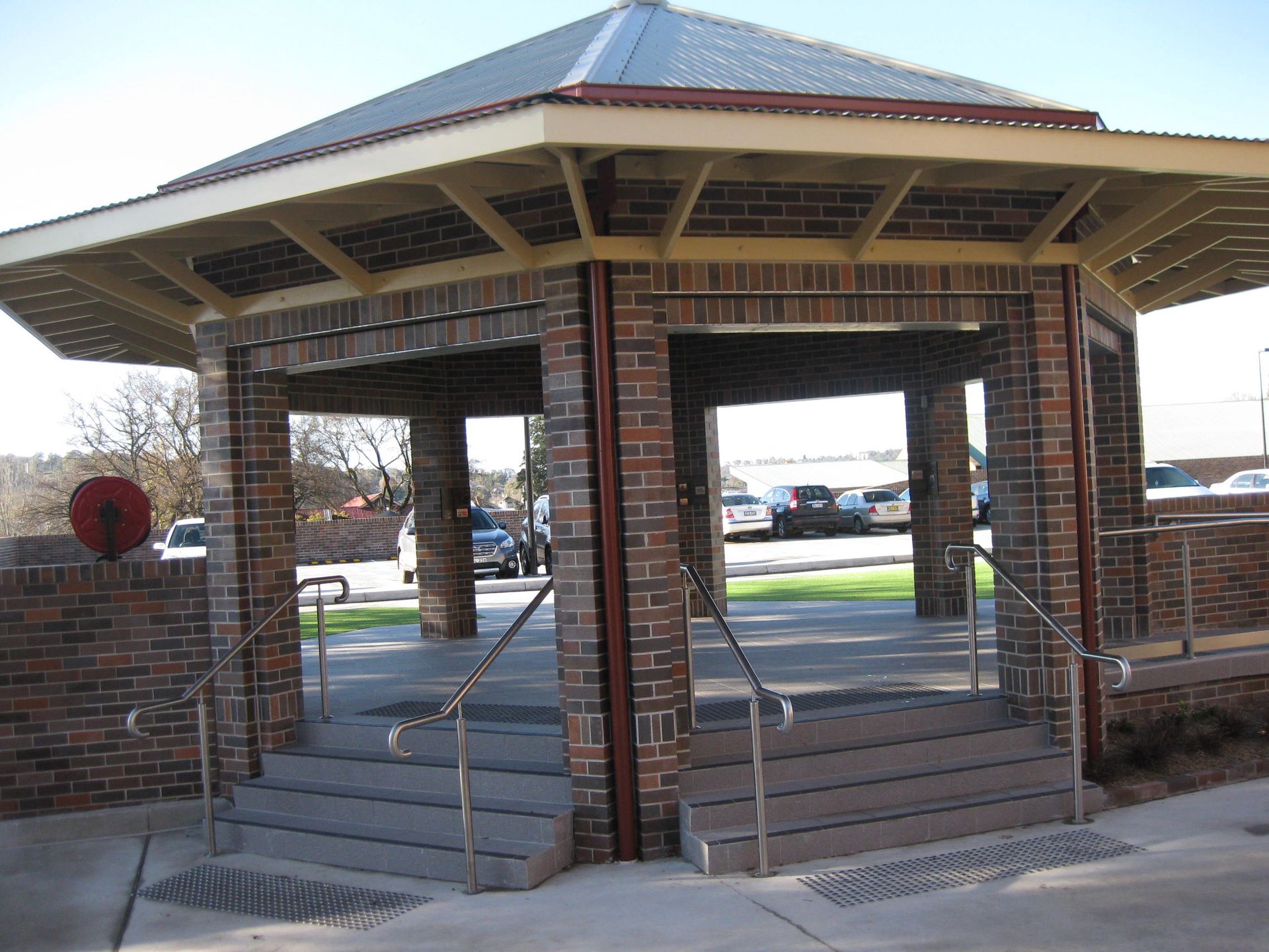 a brick gazebo with stairs leading up to it