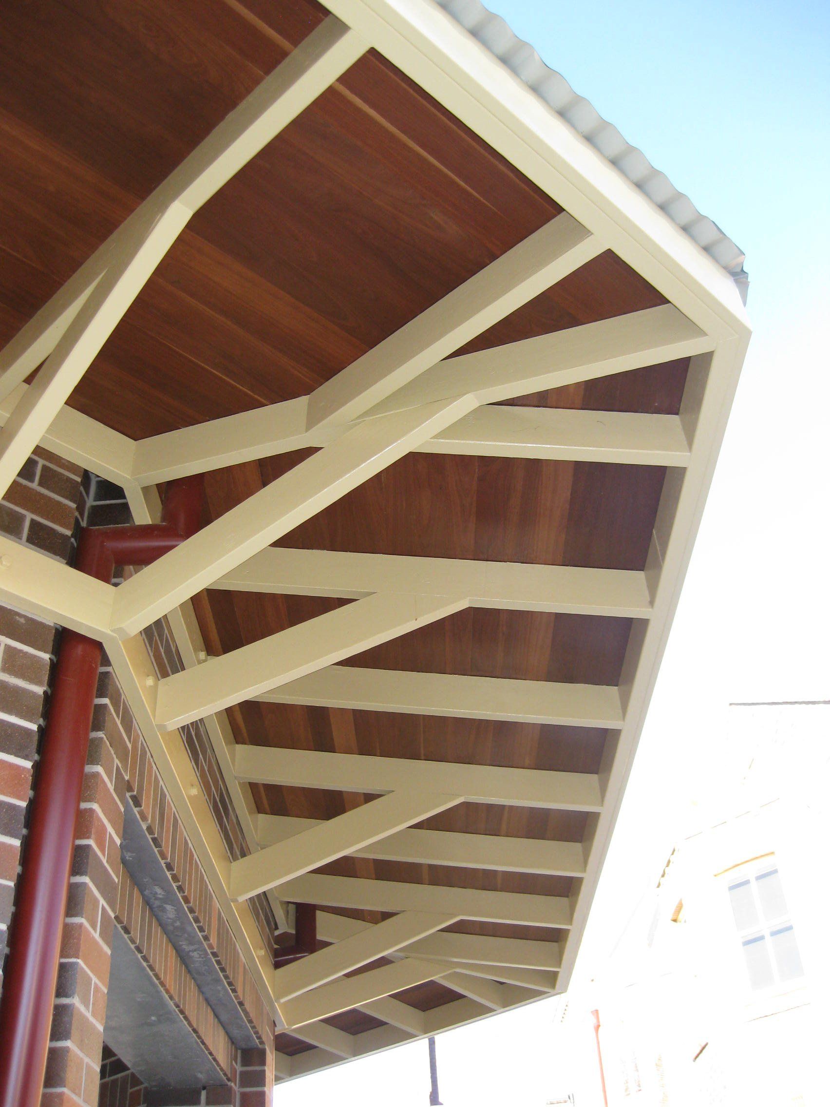side of gazebo with a wooden roof and white beams