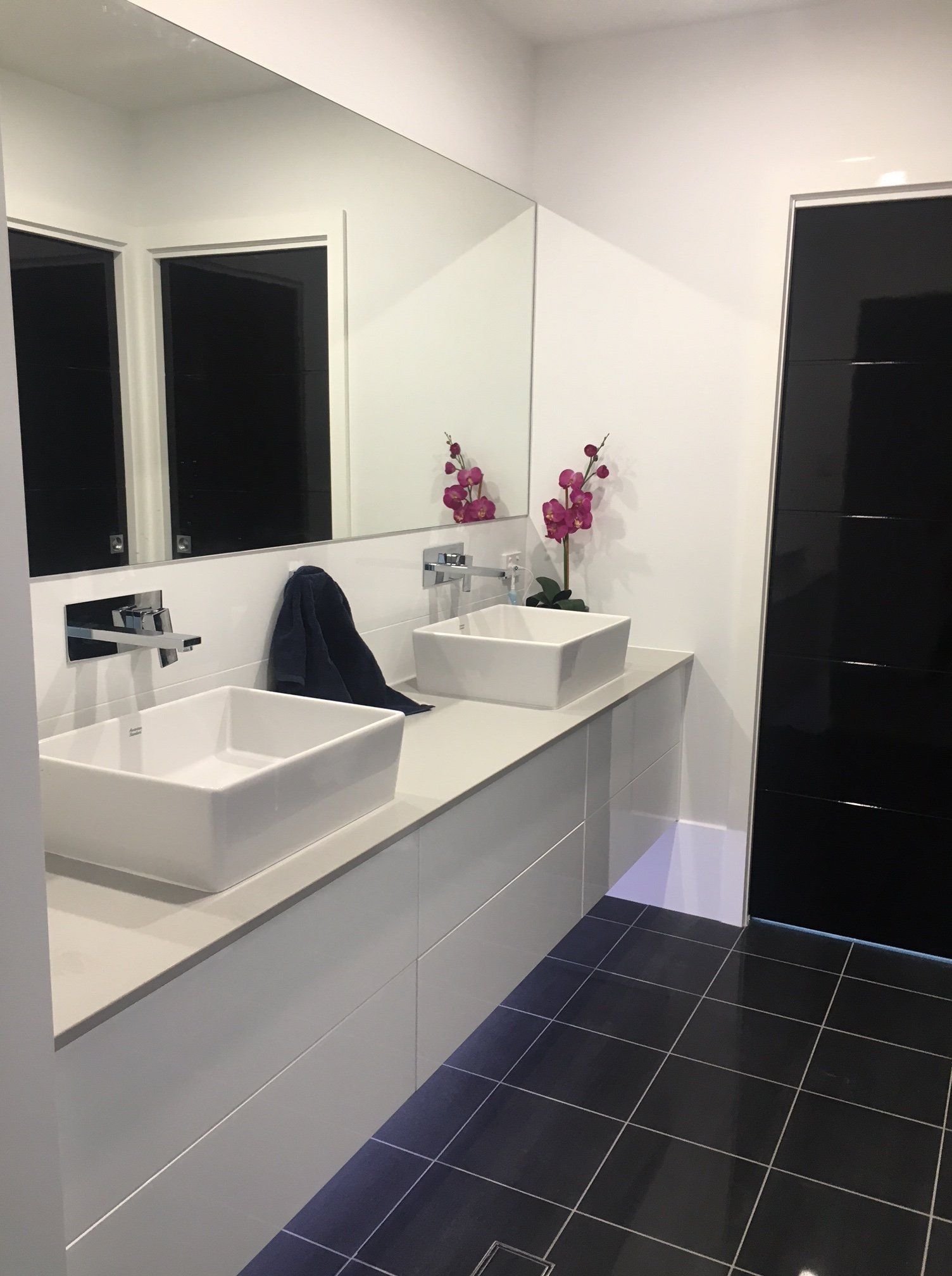 a bathroom with two sinks and two mirrors .