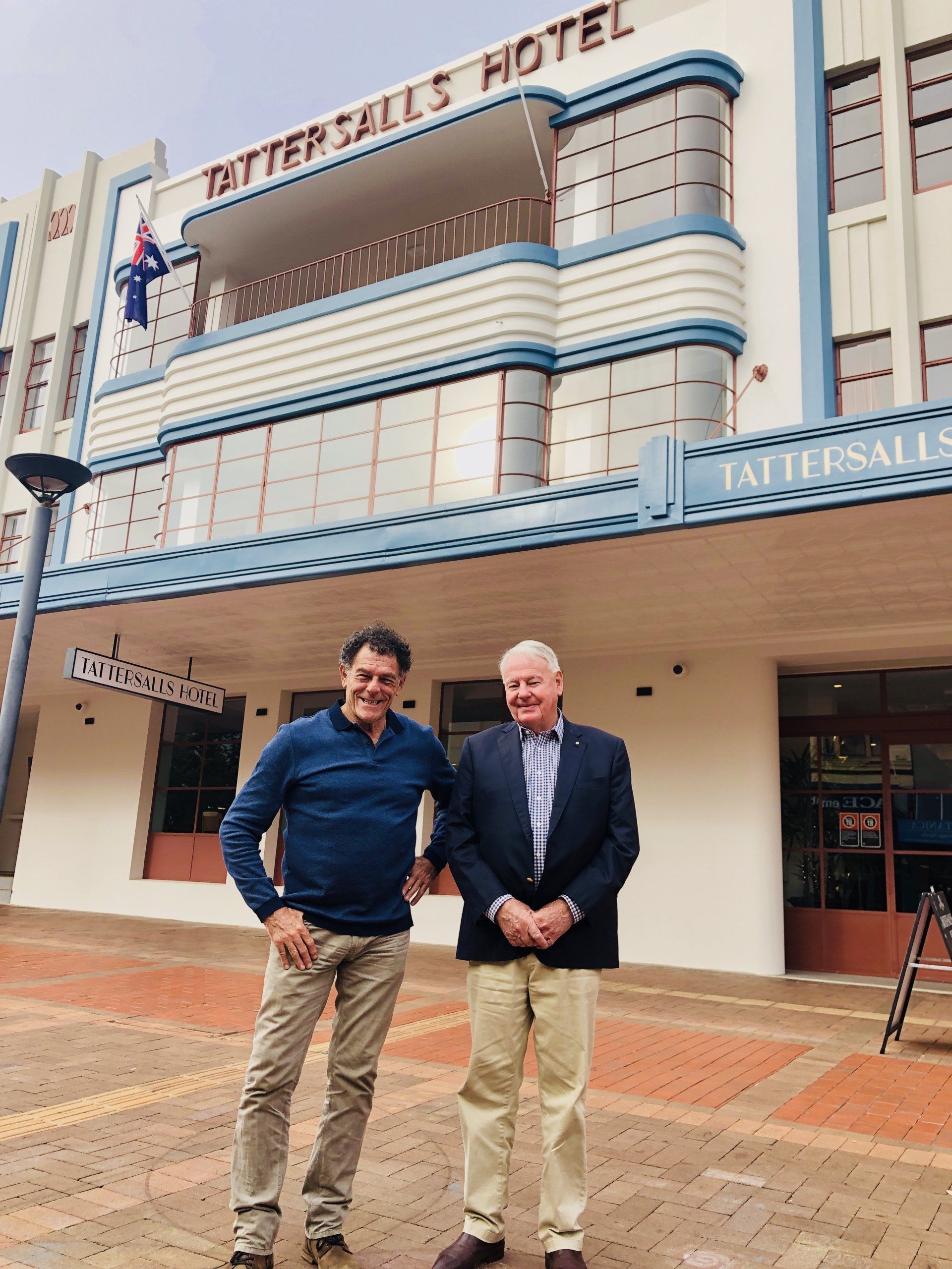 two men standing in front of the tattersalls hotel