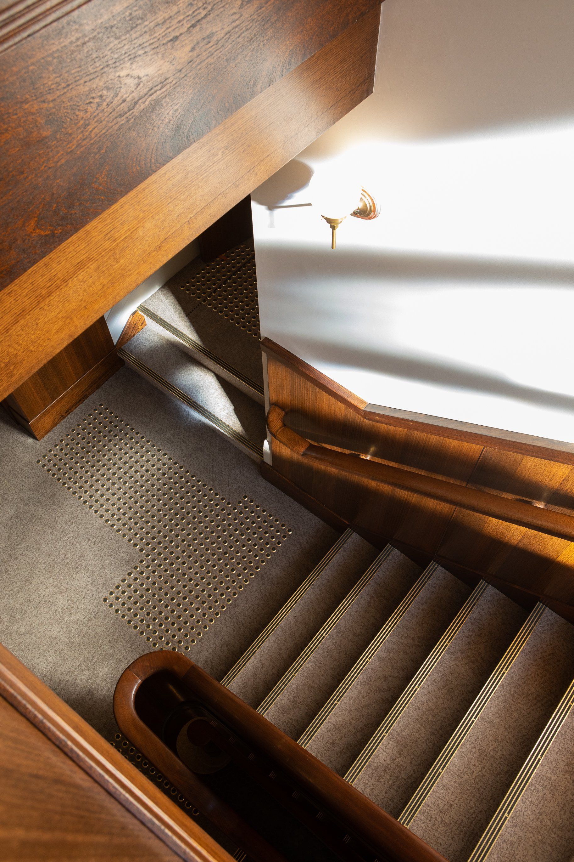 a close up of a staircase with a wooden railing