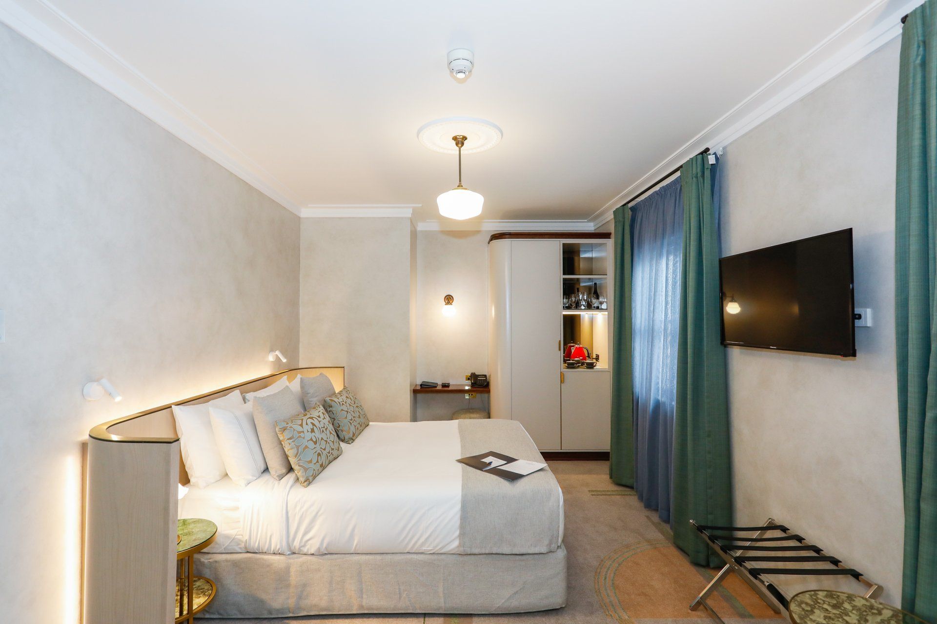 hotel room at tattersalls hotel with green curtains and cream textured walls 