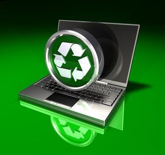 A laptop with a green recycling symbol on the screen