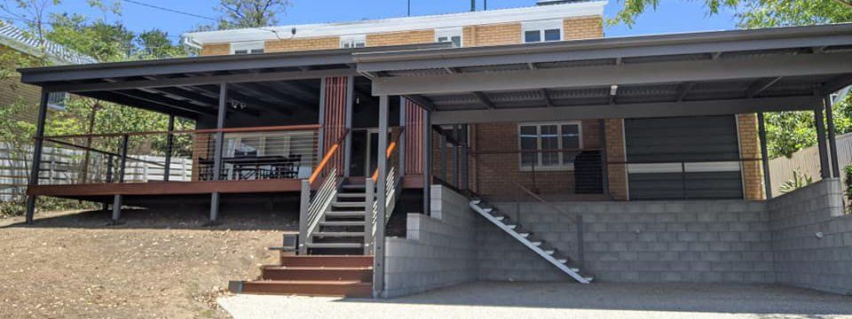 modern home with carport and metal stairs