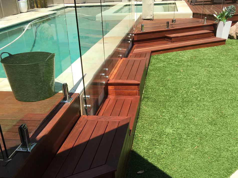 wood pool deck next to grass