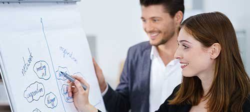 man and woman in front of a flipchart