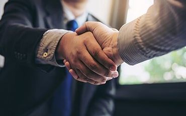 Two men handshaking — Environmental Branding in Stetson, ME Two men handshaking — Environmental Branding in Stetson, ME