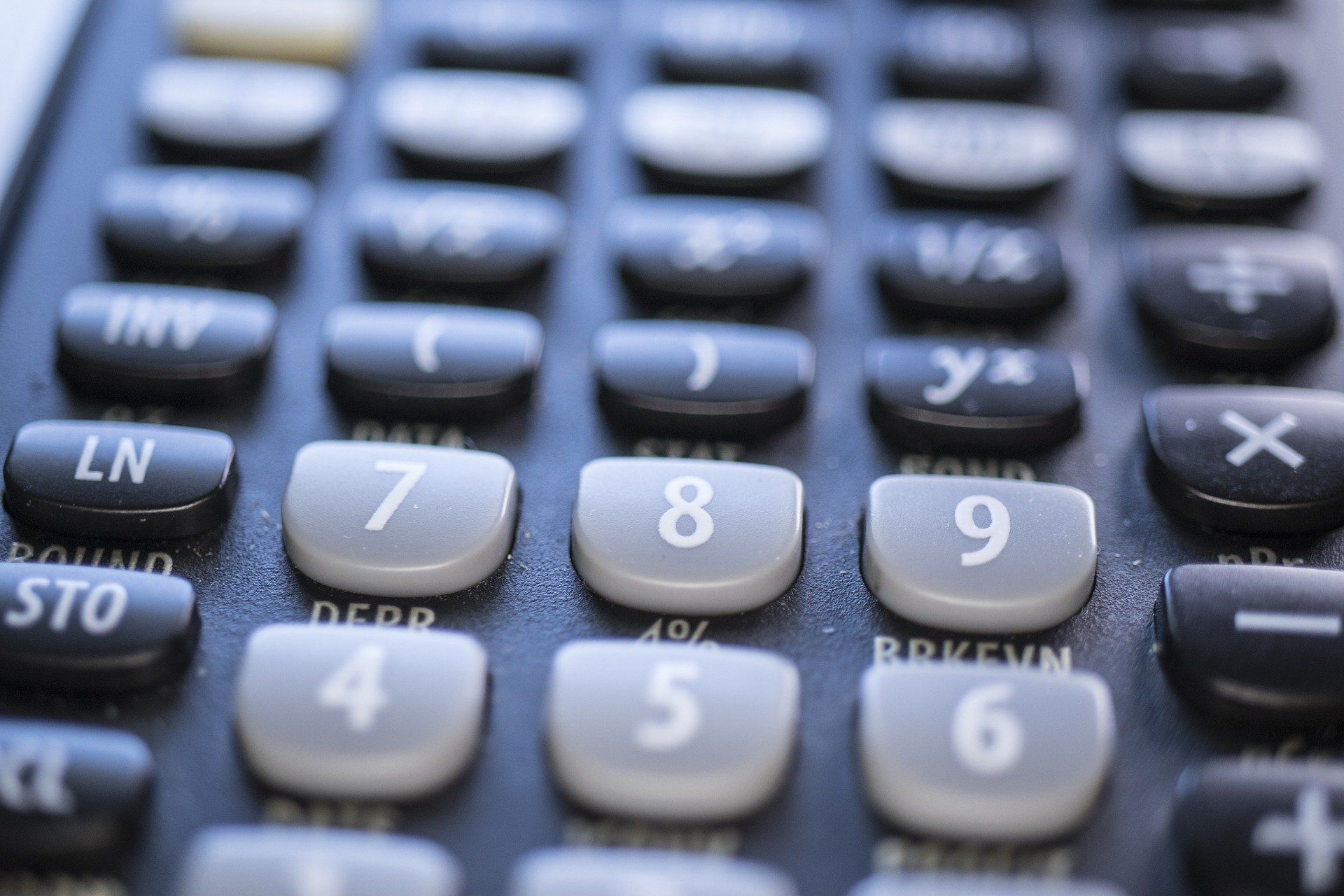 Close-up of a calculator keypad with numbers, symbols, and function keys in various colors.