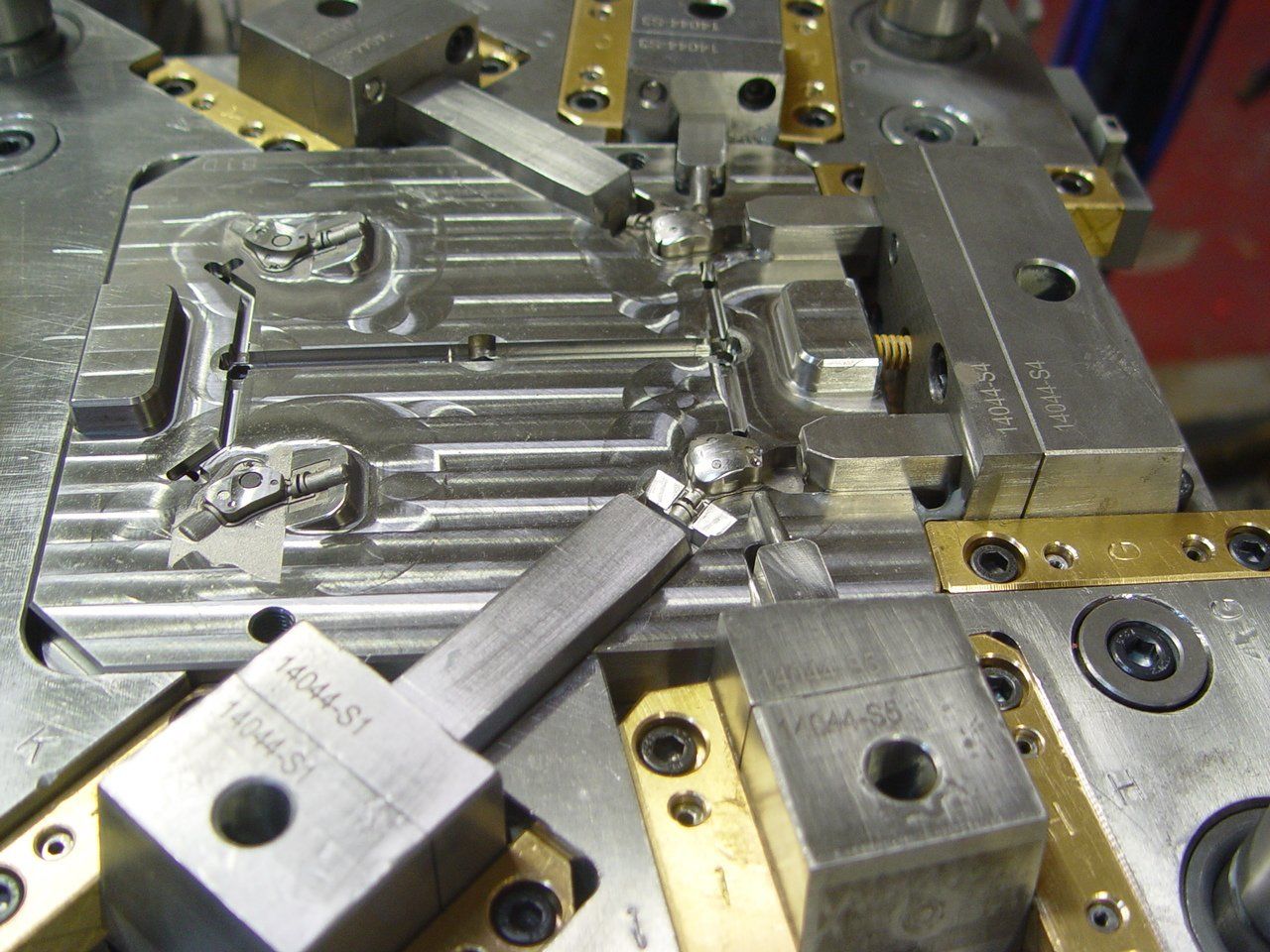 A close up of a metal mould with a few pieces of metal on it
