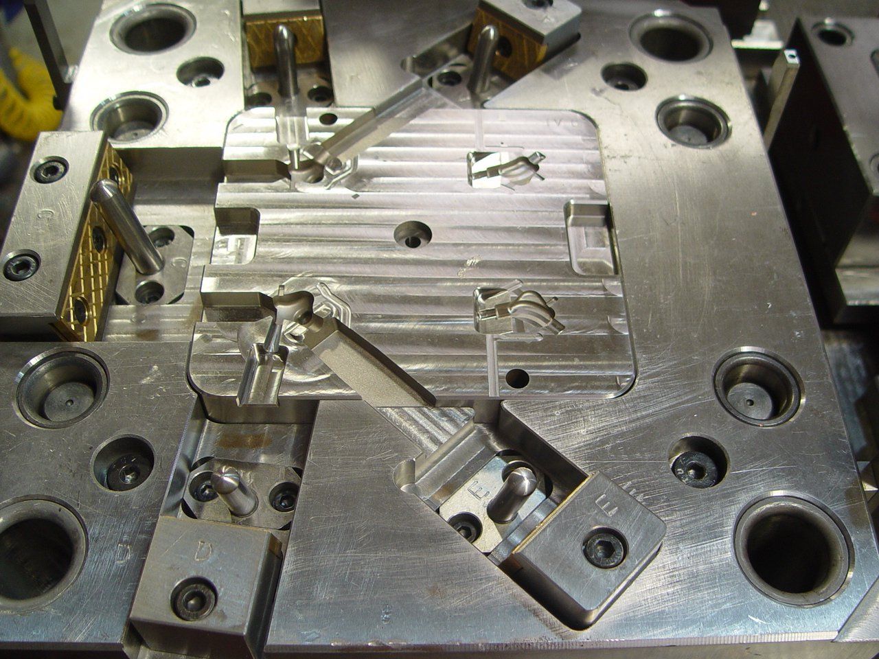 A close up of a metal mould with holes in it