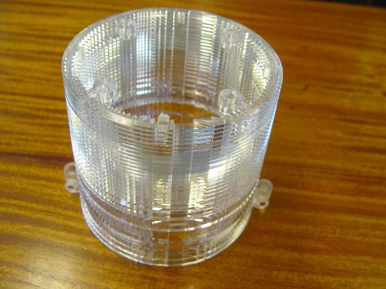 A clear plastic object is sitting on a wooden table