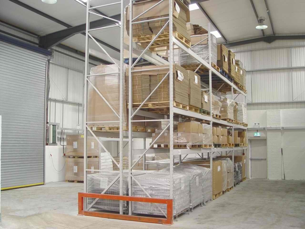 A large warehouse filled with lots of boxes on shelves
