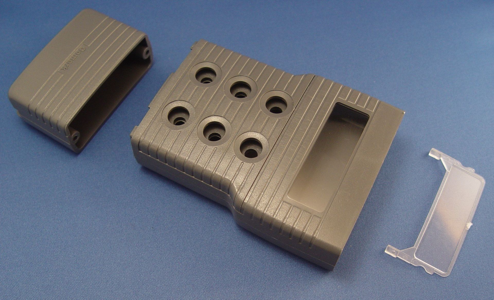 A gray box with holes in it is sitting on a blue surface